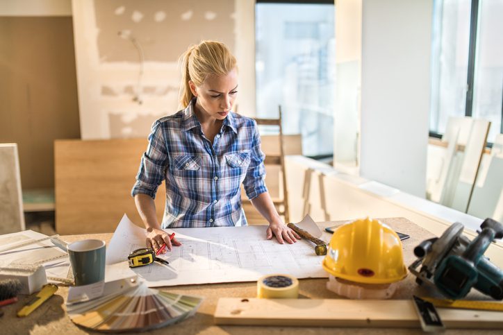 Polk Electric LLC | Young building contractor examining housing project on construction site.